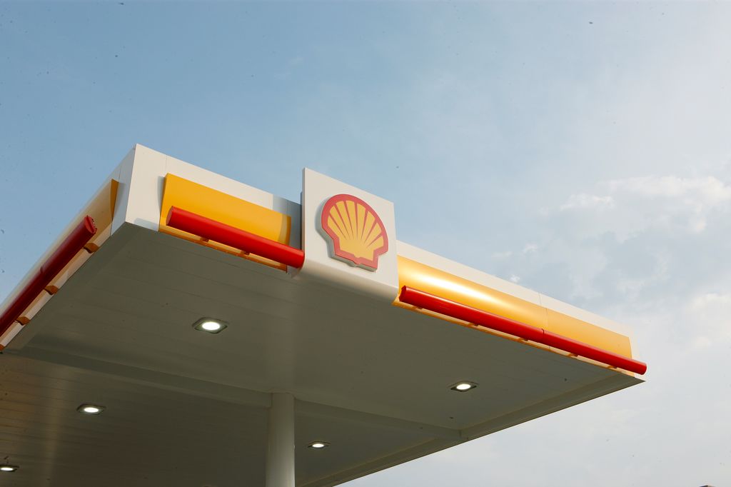 Shell logo on the roof of a gas station with yellow and red accents.