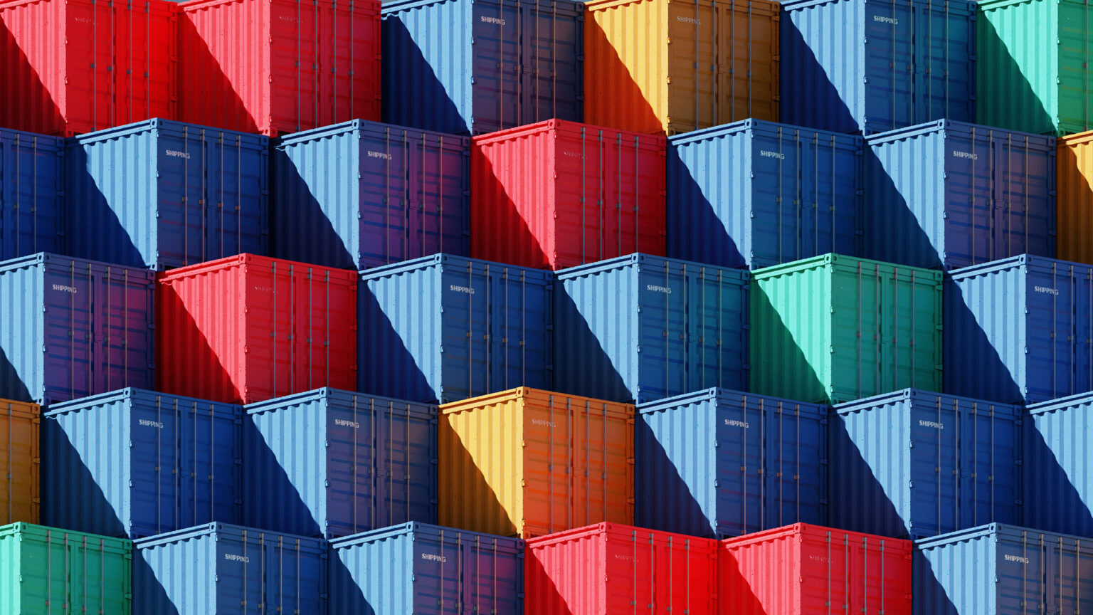 Gestapelte Frachtcontainer in verschiedenen Farben, darunter Rot, Blau, Grün und Gelb.
